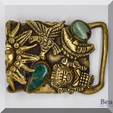 J073. Brass carved belt buckle with green stones. - $28 